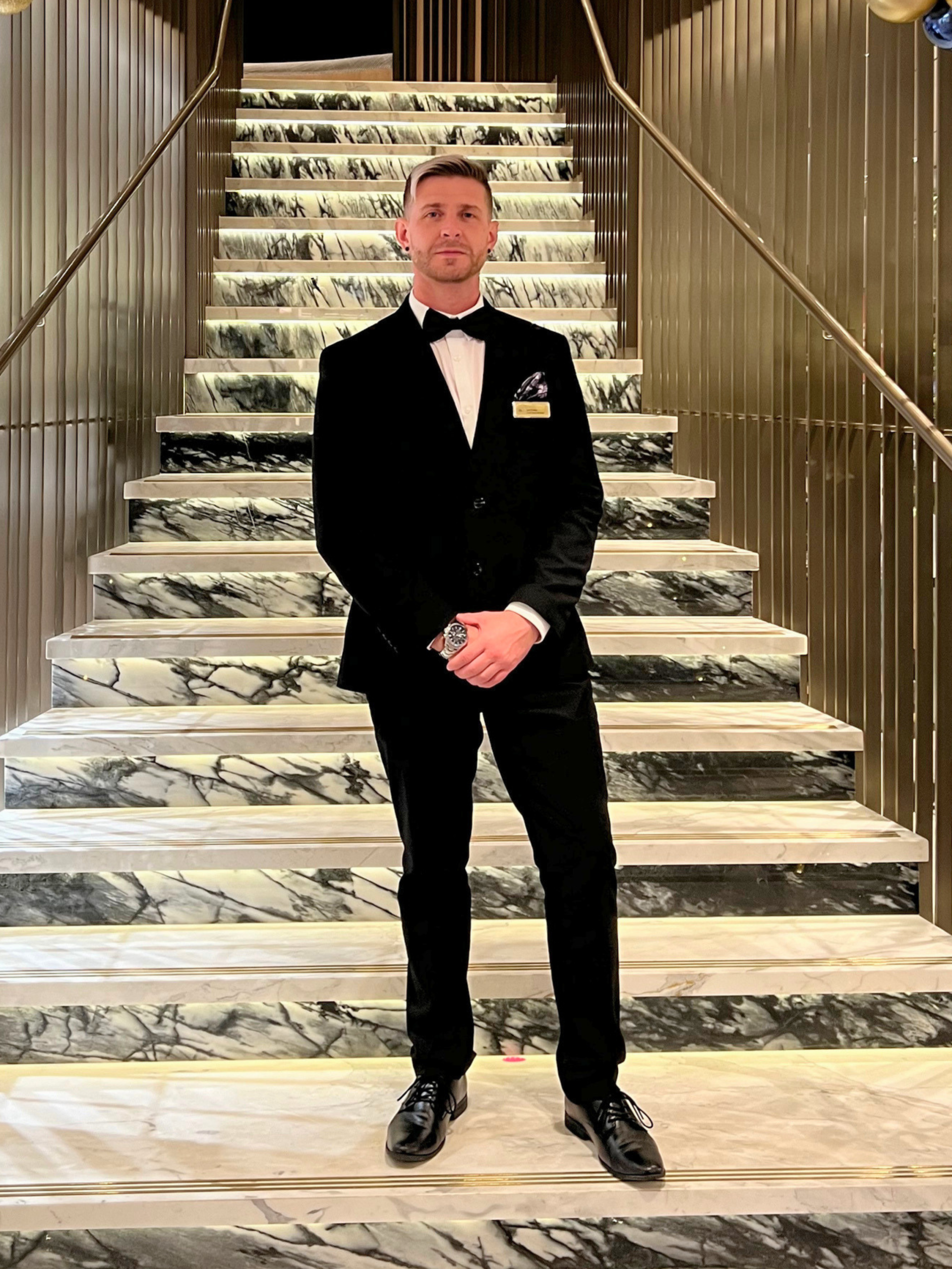 Lee in black tie, working in retail management